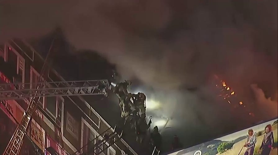 Los Angeles firefighters battle a blaze at a Westlake District apartment complex