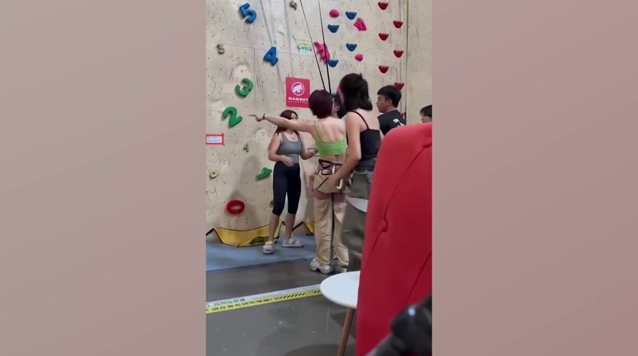 Risky stunt backfires as climber falls and gets rescued mid-drop by quick hero