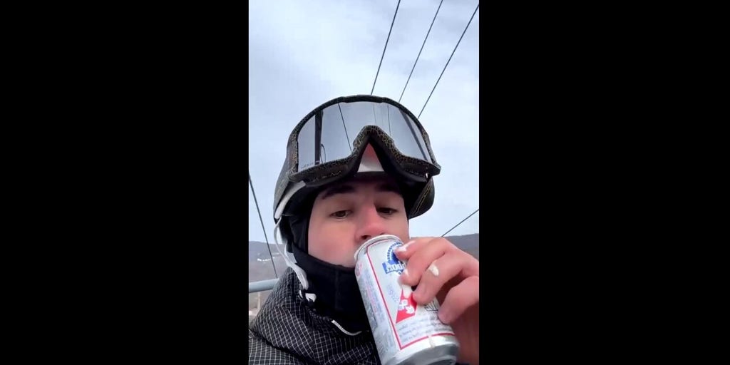 Snowboarder makes impressive beer catch on chairlift