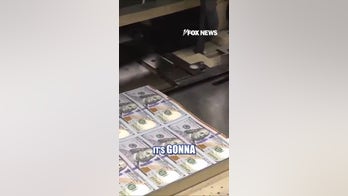 A look at the $100 bills with the Trump touch