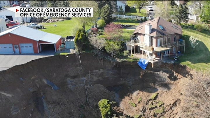 NY home seen dangling over cliff after landslide