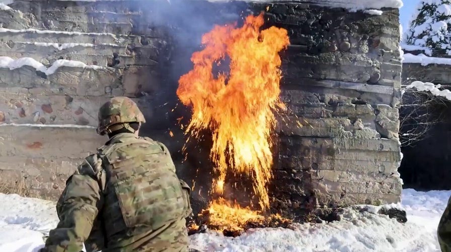 US soldiers throw Molotov cocktails into wall, creating fiery explosions