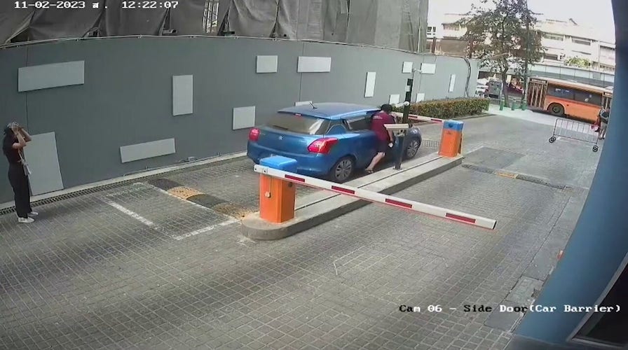 Driver crashes through car park barrier: Scary moment caught on camera