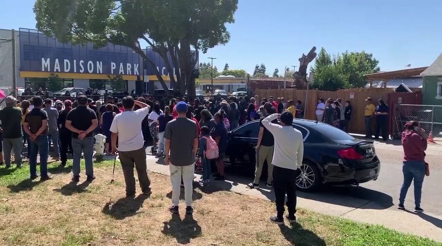 Parents at an East Oakland middle school wait to be reunited with their children after a reported shooting