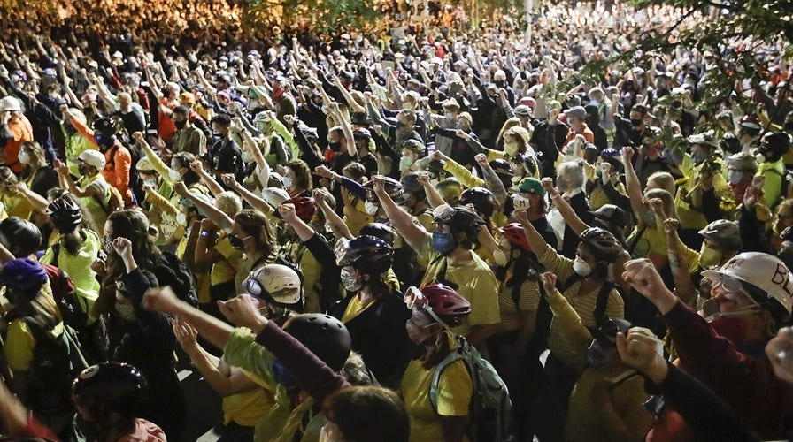 2,000 Portland protesters descend on US courthouse, city says protective fence erected by feds must come down