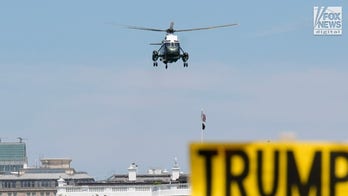 Marine One flies over May Day activists