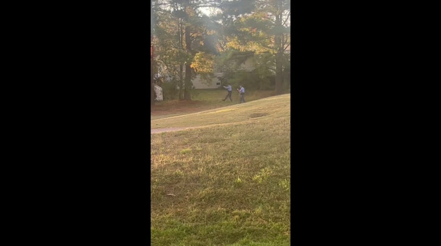 Video shows armed officers passing in front of house in Raleigh, NC