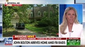 John Bolton returns home after FBI raid