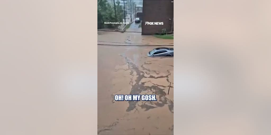 POWERFUL flash flood carries sedan down road
