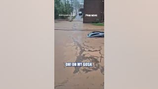 POWERFUL flash flood carries sedan down road