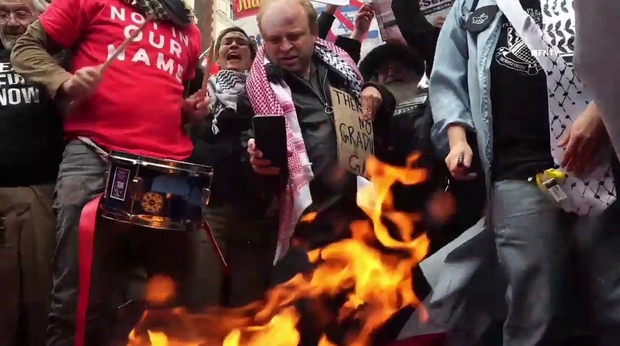 Columbia University students rip up, burn diplomas after graduating