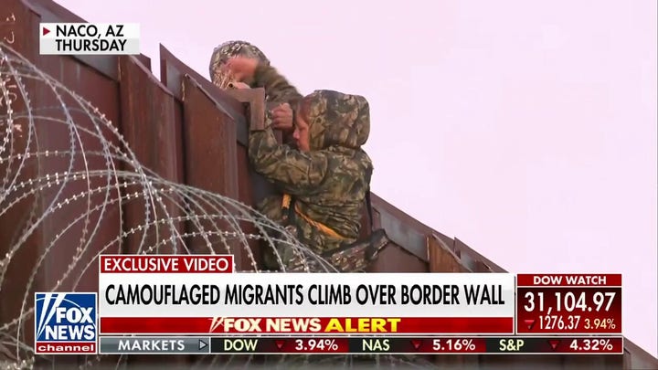 Camouflaged migrants seen climbing over border wall: 'I'm at a loss for words'