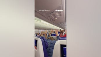 Diverted Southwest passengers hold hands up amid threat investigation
