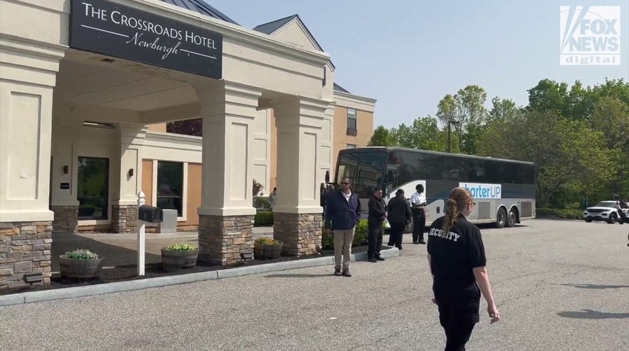 Migrants arrive by bus at The Crossroads Hotel in Newburgh, NY