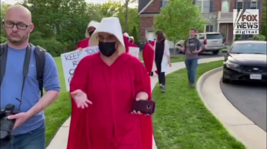 "Handmaid's Tale" protester says Justice Amy Coney Barrett does not understand what it is like to bring a child to term as an adoptive mother