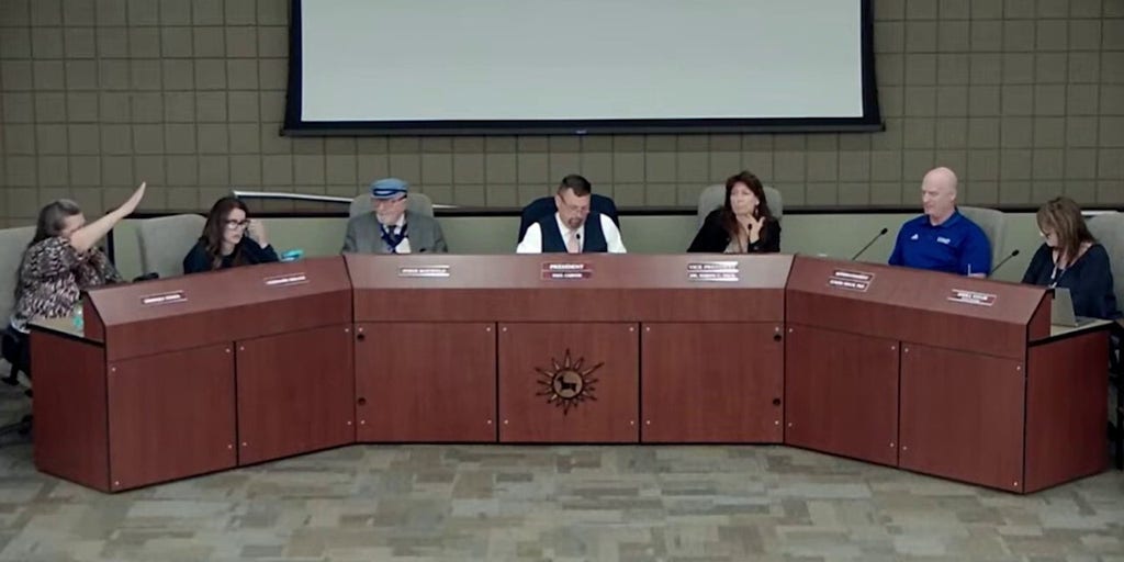 Arizona school board member appears to mock president with Nazi salute during contentious public meeting