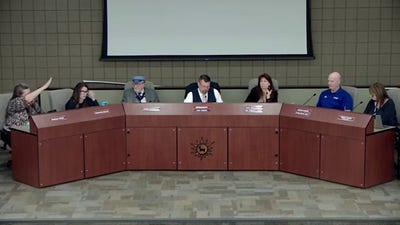 Arizona school board member appears to mock president with Nazi salute during contentious public meeting