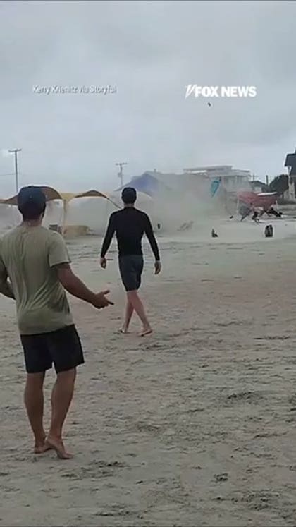 Waterspout turned TORNADO sends beachgoers running for cover
