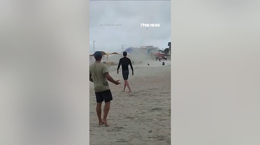 Waterspout turned TORNADO sends beachgoers running for cover
