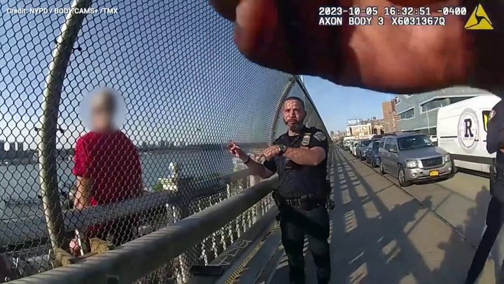Police officers rescue man from side of bridge