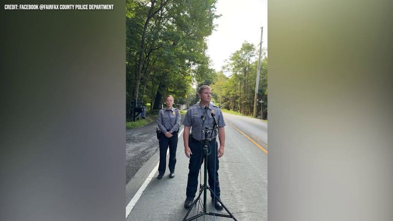 Woman found dead outside car in affluent neighborhood