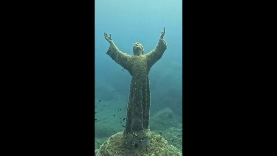 Divers scrub famed Christ of the Abyss statue during annual underwater cleanup