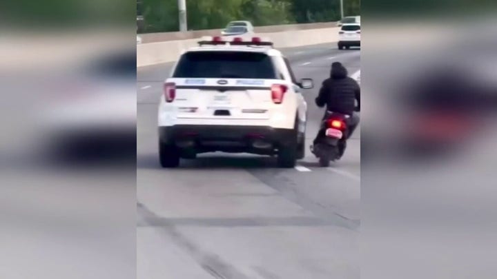 New York City police vehicle swerves dangerously close to moped