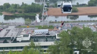 Families rescued after violent storms leave cable car dangling above river