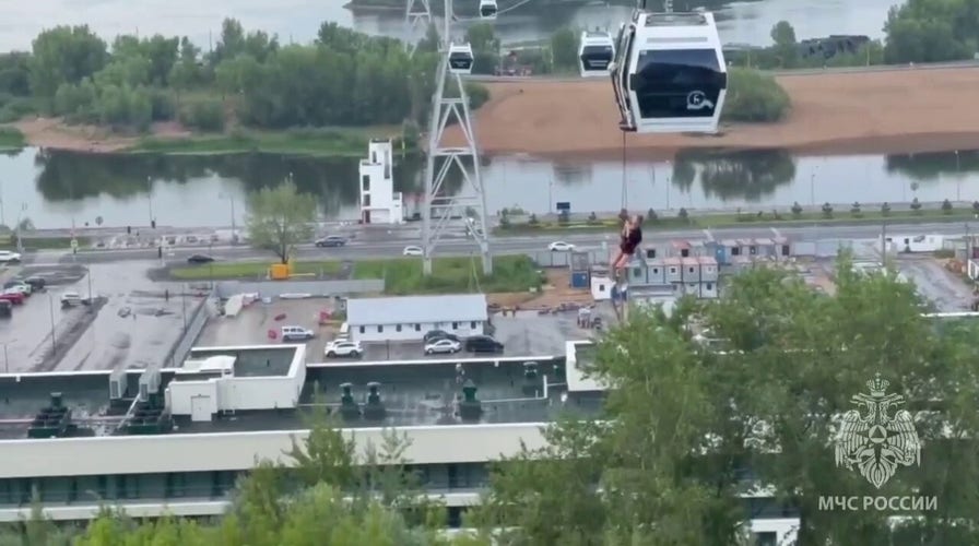 Families rescued after violent storms leave cable car dangling above river