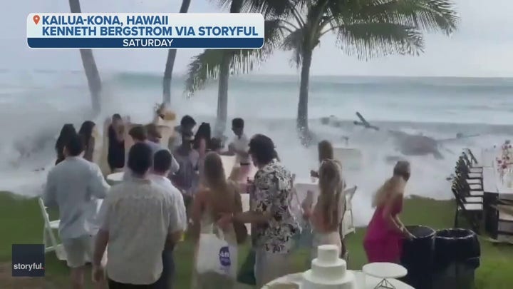 A wave crashes a wedding in Hawaii