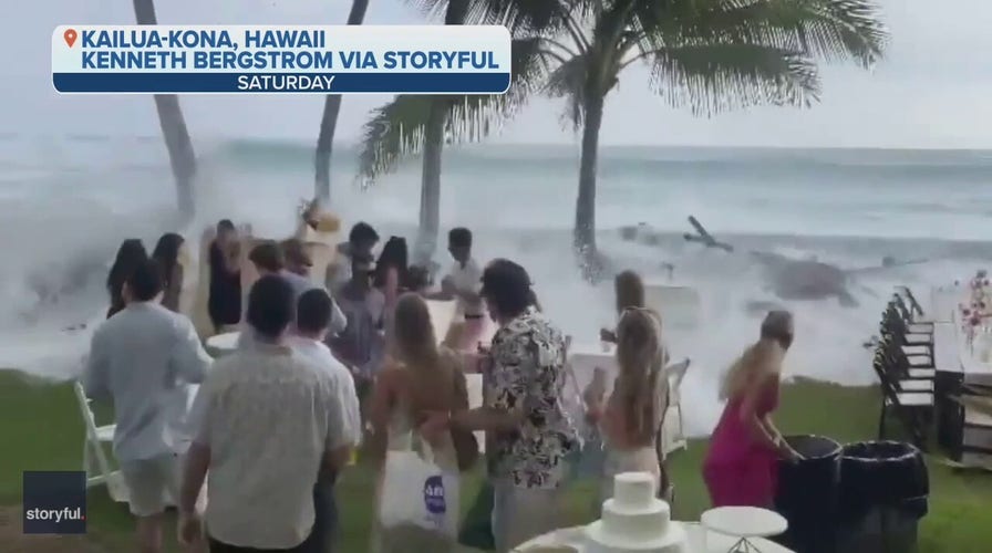 A wave crashes a wedding in Hawaii