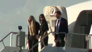 Erika Kirk holds hands with Usha Vance as they step off Air Force Two