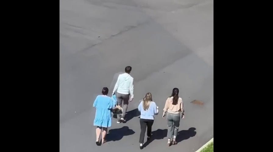 Children escorted across parking lot following school shooting n Nashville