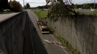 Military vehicle plunges over retaining wall