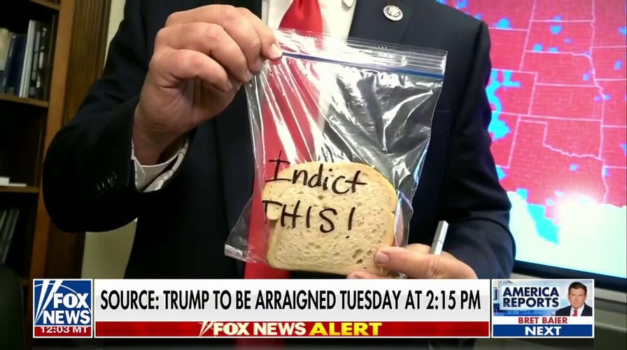 Republican hands out ham sandwiches in protest of Trump indictment. 