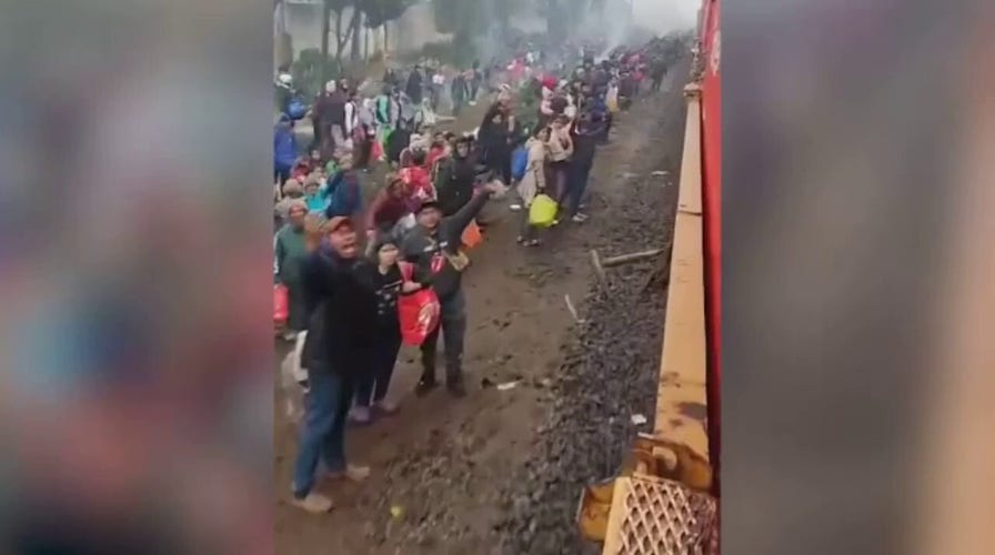 Video shows migrants 3 hours south of Eagle Pass, Texas, waiting to catch a passing freight train