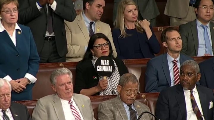 Rep. Rashida Tlaib, D-Mich., holds up sign that says 'war criminal' during Netanyahu address