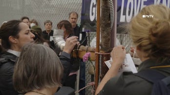 Anti-ICE protesters hold worship service with makeshift cross