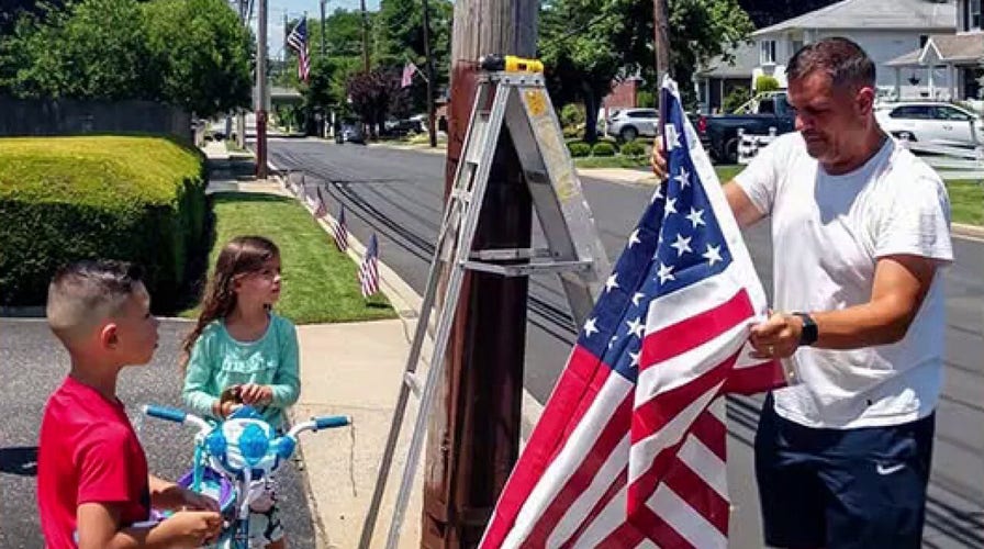 Community raises money to place hundreds of American flags throughout neighborhood