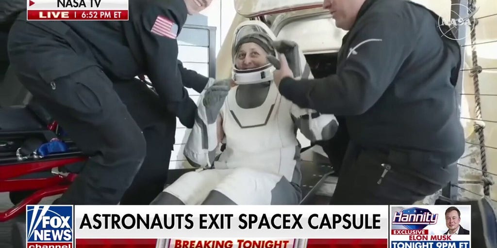 Astronauts exit Dragon capsule after return to earth