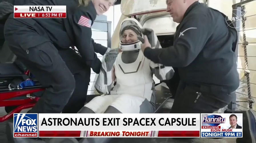 Astronauts exit Dragon capsule after return to earth