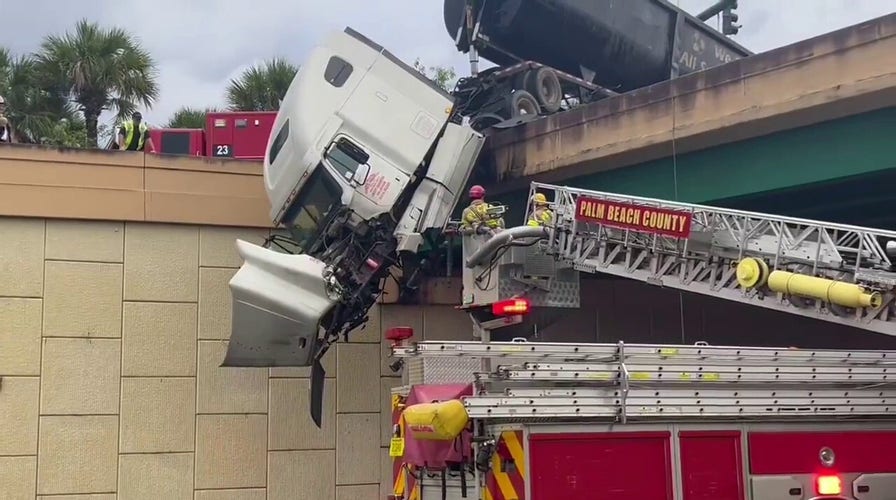 Palm Beach County Fire Department rescues truck driver from dangling 18-wheeler