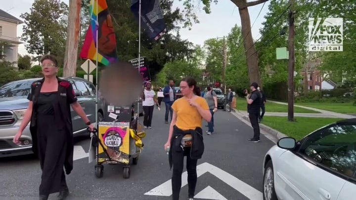 Pro-choice protestors gather outside of Chief Justice Roberts' house