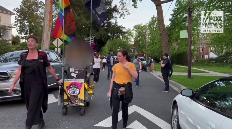 Pro-choice protestors gather outside of Chief Justice Roberts' house