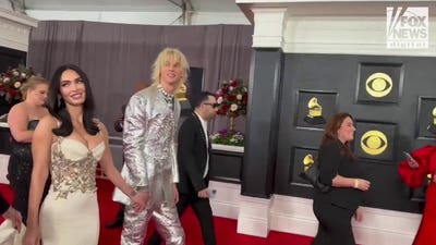 Machine Gun Kelly and Megan Fox walk the Grammy Awards red carpet together