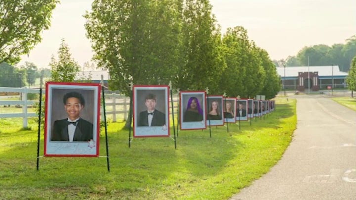 Florida principal lines school driveway with portraits of class of 2020