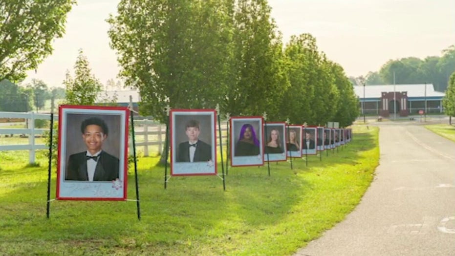 Florida principal lines school driveway with portraits of class of 2020