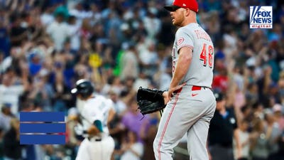 Reds pitcher gets irate at umpire for getting in defender's way