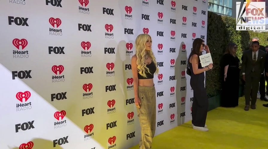 Tori Spelling walks the red carpet at the 2024 iHeartRadio Music Awards