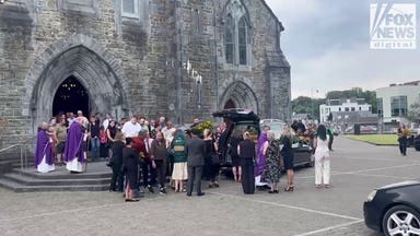 Mourners gather around murdered American mother Jamey Carney's hearse outside Killarney cathedral